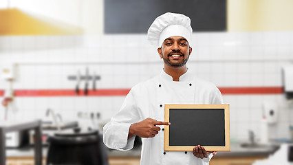 Image showing indian chef with chalkboard at restaurant kitchen