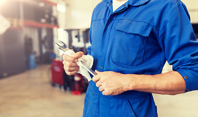 Image showing auto mechanic or smith with wrench at car workshop