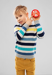 Image showing nice boy in striped pullover with alarm clock