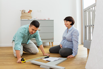 Image showing family couple assembling baby bed at home