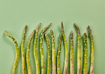 Image showing fresh asparagus on green background