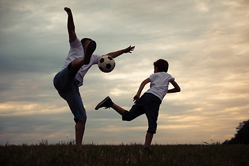 Image showing Father and young little boy playing in the field  with soccer ba