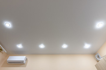 Image showing On the stretch ceiling are located on the preimeter point light bulbs