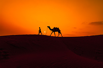 Image showing Cameleers, camel Drivers at sunset. Thar desert on sunset Jaisal