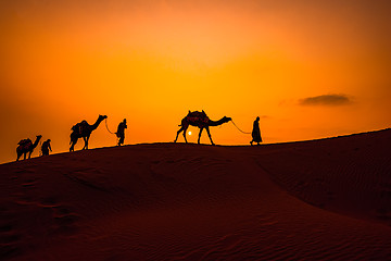 Image showing Cameleers, camel Drivers at sunset. Thar desert on sunset Jaisal