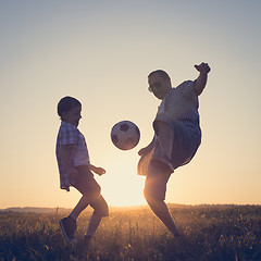 Image showing Father and young little boy playing in the field  with soccer ba