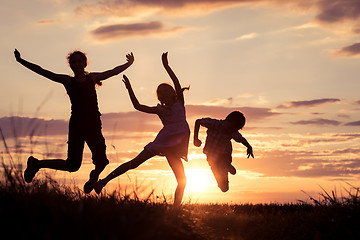 Image showing Happy children playing in the park at the sunset time.