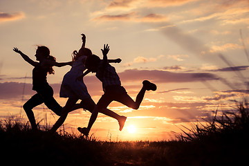 Image showing Happy children playing in the park at the sunset time.