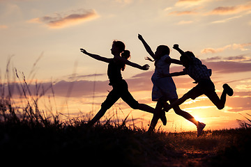 Image showing Happy children playing in the park at the sunset time. 