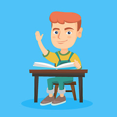 Image showing Pupil raising hand while sitting at the desk.