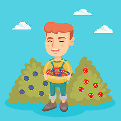 Image showing Boy with the basket of strawberry and blueberry.