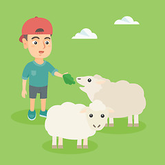 Image showing Little caucasian boy feeding a sheep with salad.