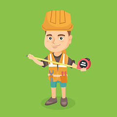 Image showing Caucasian boy in hard hat using a measuring tape.
