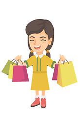 Image showing Happy caucasian girl holding shopping bags.