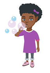 Image showing Little african-american girl blowing soap bubbles.
