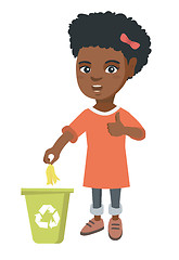 Image showing Little girl throwing banana peel in recycling bin.