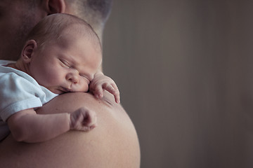 Image showing Father holding newborn baby son at the day time.