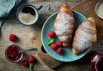 Image showing freshly baked croissants on wooden table