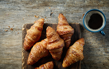 Image showing freshly baked croissants on wooden table