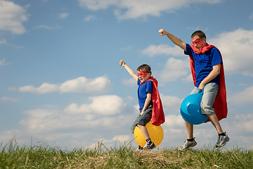 Image showing Father and son playing superhero at the day time.