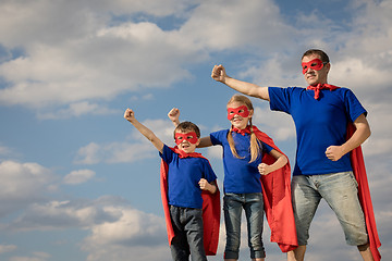 Image showing Father and children playing superhero at the day time.