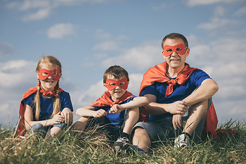 Image showing Father and children playing superhero at the day time.