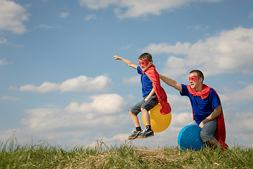 Image showing Father and son playing superhero at the day time.