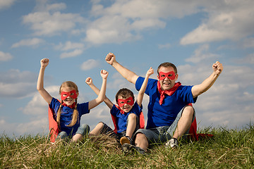 Image showing Father and children playing superhero at the day time.