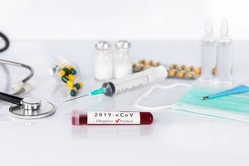 Image showing Blood test tube with the Coronavirus disease for virus test and 