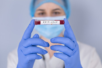 Image showing Nurse holding test tube with Positive Coronavirus test blood sam