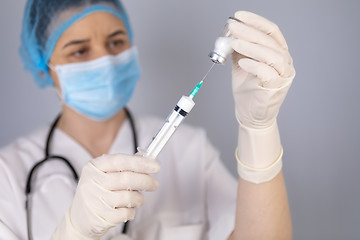 Image showing Doctor hands filling the syringe with vaccine