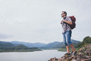 Image showing Happy man standing near the lake at the day time.