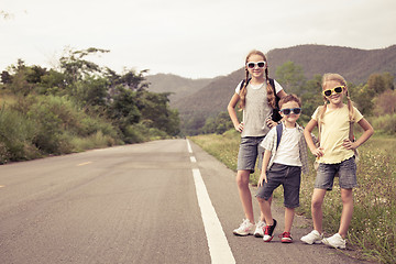 Image showing Happy children  walking on the road at the day time. 