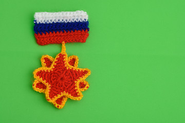 Image showing An embroidered order with the flag of Russia on a green background