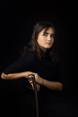 Image showing Portrait of a fifteen-year-old girl on a black background, a girl clouded on the back of a chair