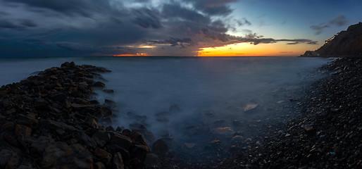 Image showing Panorama of three frames a general view of the rocky shore of the Black Sea coast after sunset, Anapa, Russia