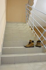 Image showing There are discarded boots on the stairs