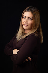 Image showing Portrait of a thirty-five-year-old woman on a black background in a dark dress