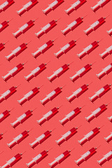 Image showing Health-care pattern of disposable syringes with red liquid.