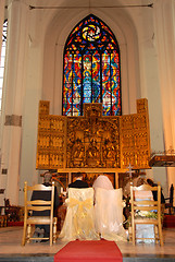 Image showing Young couple at the altar