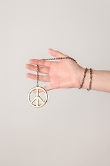 Image showing Female hand holding peace sign