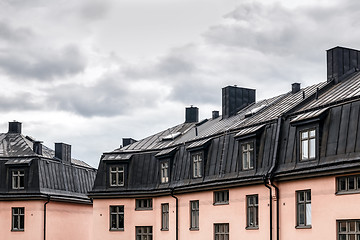 Image showing Pastel colored buildings with black roofs