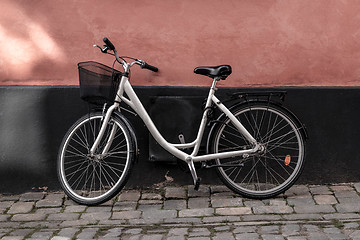 Image showing Bicycle near pink and black wall