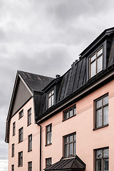 Image showing Pastel colored building with black roof