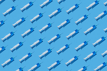 Image showing Health-care pattern of disposable syringes with blue liquid.
