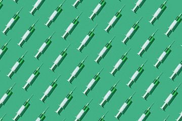 Image showing Medicinal pattern from syringes with green drugs or vaccine.