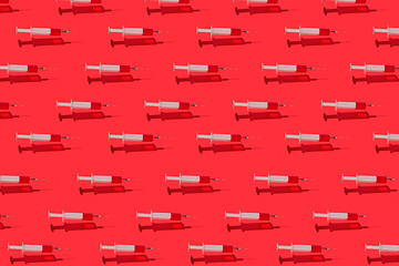 Image showing Medical pattern of flying syringes with red blood or vaccine.