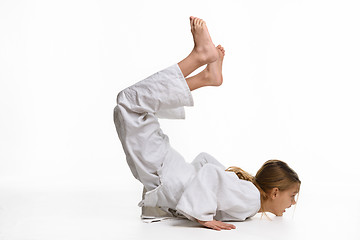 Image showing Girl judo student performs warm-up