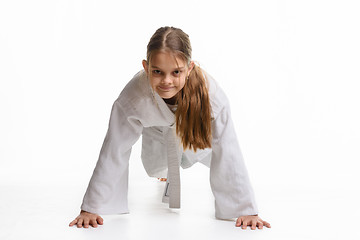 Image showing Girl push-UPS from the floor in a sports keikogi