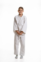 Image showing Funny and humble girl in a kimono, isolated on a white background